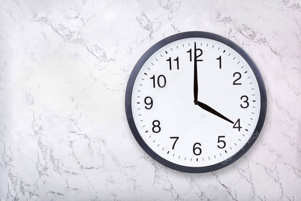 Wall clock show four oclock on white marble texture. Office clock show 4pm or 4am
