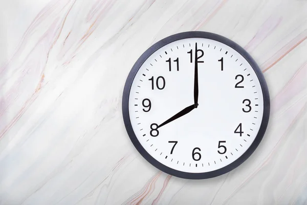 Wanduhr zeigt acht Uhr auf Marmor Textur. Bürouhr zeigt 8pm oder 8am — Stockfoto