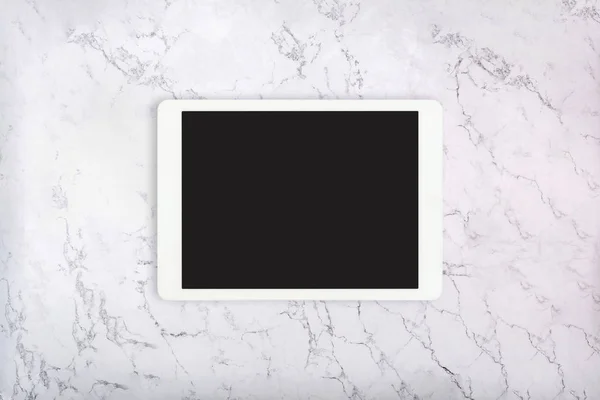 White touchpad on white marble texture. Tablet computer on marble background. Flat lay — Stock Photo, Image