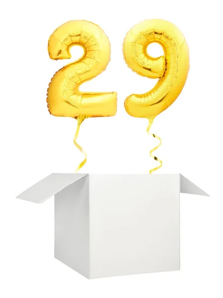 Golden number twenty nine balloon flying out of blank white box isolated on white background — Stock Photo, Image