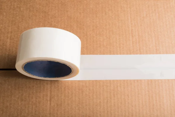 Cardboard box with white adhesive tape with copyspace — Stock Photo, Image