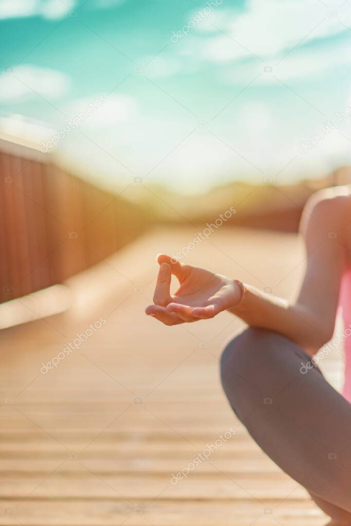 Young woman practicing yoga outdoors. Yoga woman in lotus pose