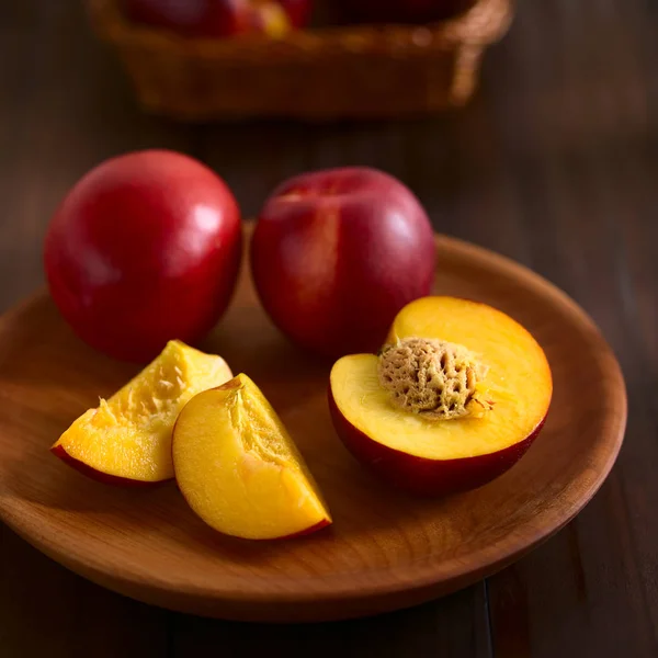 Fresh Ripe Nectarine Fruits Cut Whole Wooden Plate Photographed Dark — Stock Photo, Image