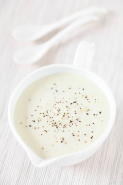 Ev yapımı Fransız Bechamel veya Beyaz Sosu sos teknesinde servis edilir, doğal ışık ile fotoğraflanır (Seçici Odaklanma, görüntünün üçte birine odaklan)