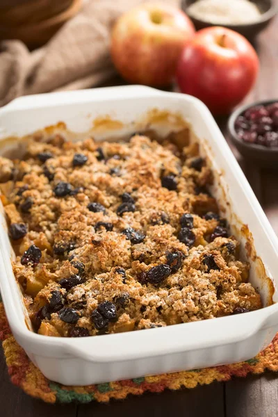 Fresh homemade baked apple, cranberry and oatmeal crumble or crisp in casserole dish (Selective Focus, Focus one third into the image)