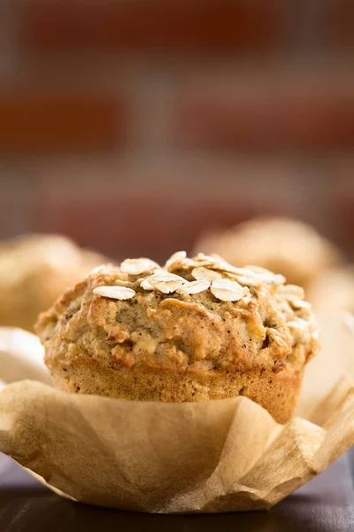 Fresh homemade apple and oatmeal muffin with oats on top (Selective Focus, Focus on the first oats on top of the muffin)