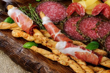 Yemek Meze aperatifler ekmek sopa için salam Ahşap yüzeyi ile jambon (grisini) ile sarılmış