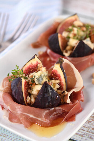 Figs stuffed with blue cheese, wrapped in Parma ham, drizzled with honey