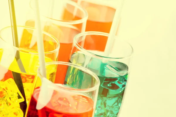 Colorful drinks in transparent glasses. Drinks closeup with cocktail straws. Drink closeup party
