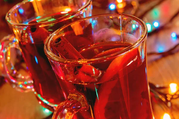 A glass of hot mulled wine. Hot drink closeup. Festive and cozy atmosphere of a country house. Fragrant spicy hot drink