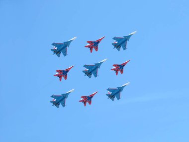 Moskova, Rusya - 9 Mayıs 2018: Mig-29 ve Su-27 savaşçıları üzerinde akrobasi grubu Rus Knights ve ebabiller gösterir Kubinsky elmas uçuş geçit uçuş mavi gökyüzü karşı 9 Mayıs 2018