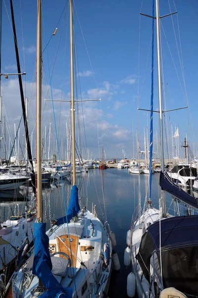 Tight marine yacht parking in calm water on bright summer day with mountains af far