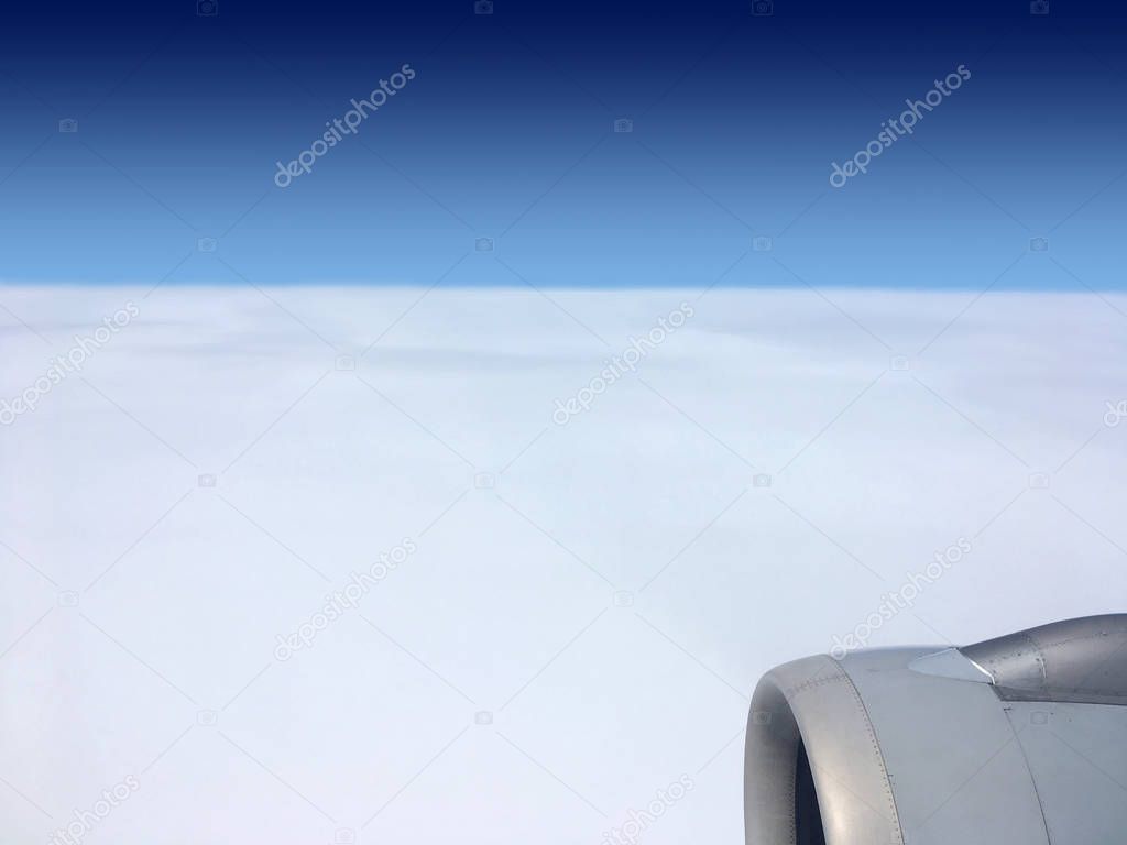 View of white havenly ocean from stratosphere from flying airplane with engine in right down corner