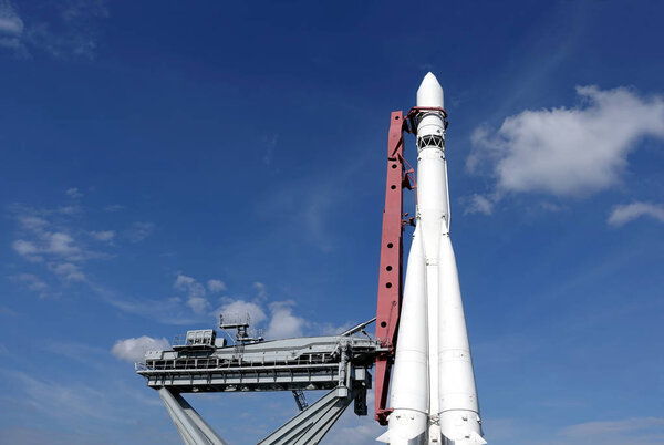 Spaceship on launch pad ready to fly into space vertical photo over blue sky horizontal photo
