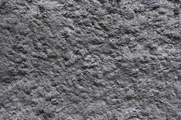 Gray solidified cooled down volcanic lava as textured background horizontal view closeup