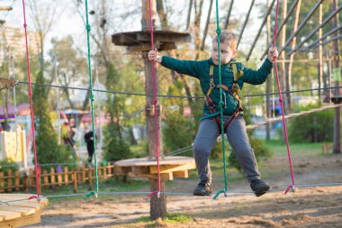 Halat parkında küçük bir çocuk. Parkta temiz havada çocuğun aktif fiziksel rekreasyon. Çocuklar için eğitim.