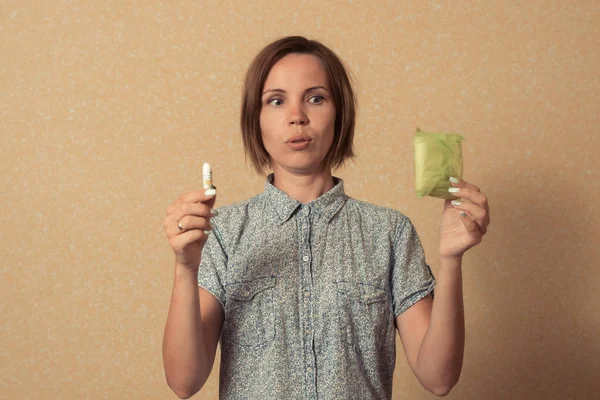 A woman makes a choice during menstruation between the sanitary pad and the pad.