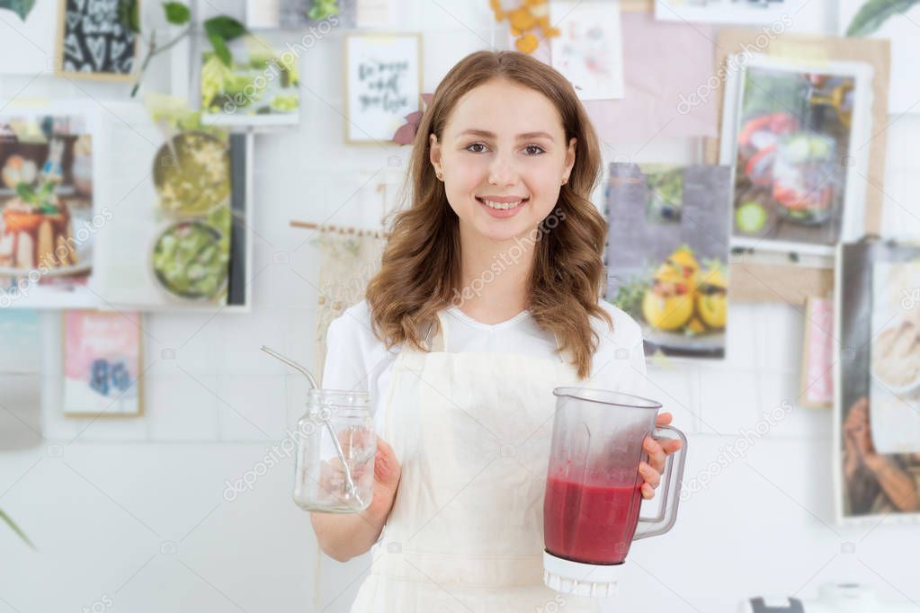 Raspberry Smoothies A woman puts fresh-frozen raspberry berries in a shaker. The concept of healthy eating.
