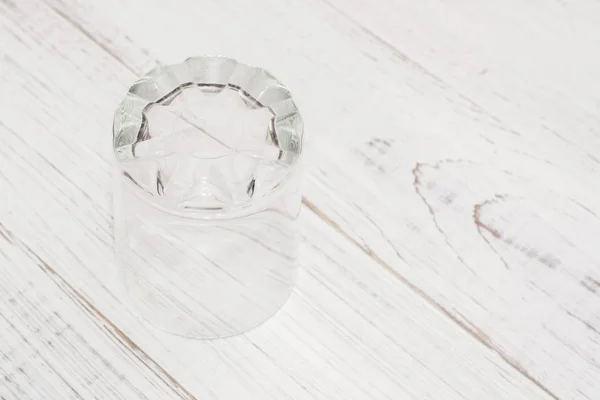 Empty glass on a white wooden background. — Stock Photo, Image