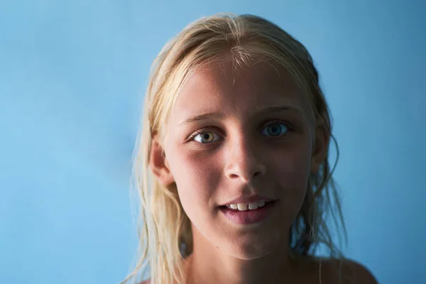 Retrato de uma adolescente sorridente em um fundo azul . — Fotografia de Stock