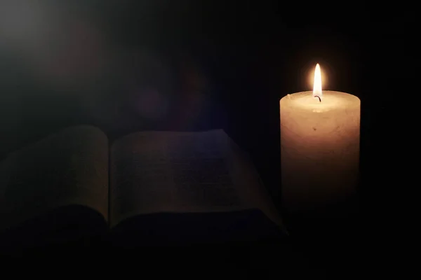 Yakıcı mum ve İncil, kitap. Tanrı 'ya, Hristiyanlığa, dine inanç kavramı.