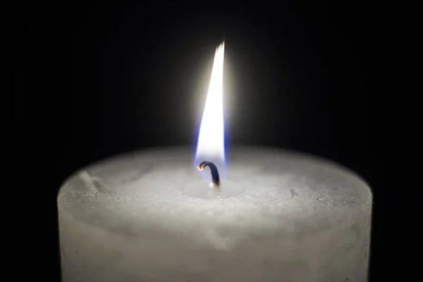 Candle flame close-up on a black background.