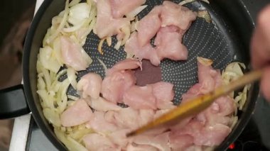 Yemek tarifi için tavada doğranmış tavuk ve soğan..