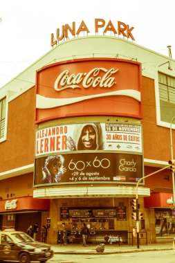 BUENOS AIRES, ARGENTINA - SEPTEMBER 20: A taxi pass in front of the famous Luna Park concert hall, on Corrientes street, Sunset in Buenos Aires, Argentina.   Vintage and yesteryear effect
