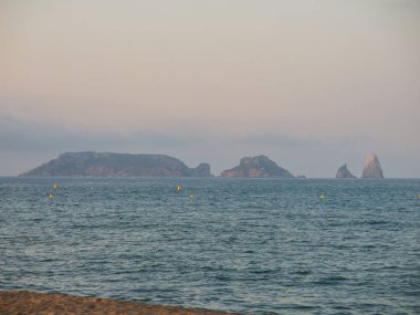 a view of the Medes Islands, in the Mediterranean sea, seen from Estartit, Costa Brava, Spain clipart