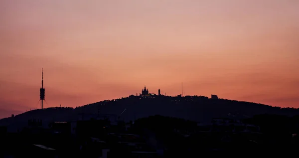 Tibidabo mountain silhouette, with the church and communications — Stock Photo, Image