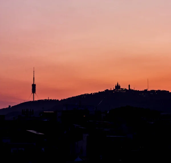 Tibidabo mountain silhouette, with the church and communications — Stock Photo, Image