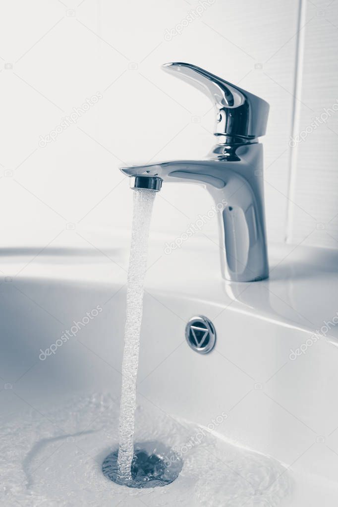 faucet and wash sink with flowing water