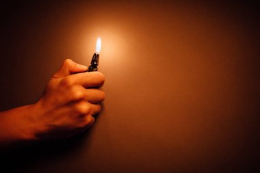cigarette lighter igniting by a hand clipart