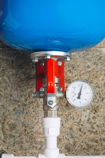 expansion tank with pressure gauge in boiler room