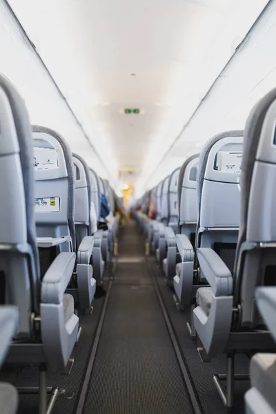 airline passenger seats and aisle in airplane cabin