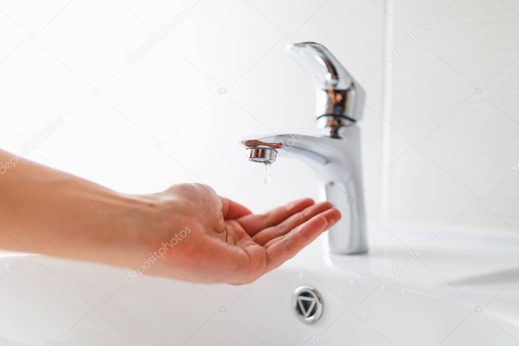 hand under faucet without water