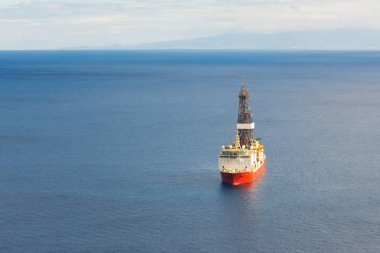 offshore oil and gas drillship, blue sea background, aerial view clipart
