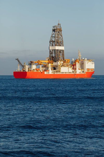 offshore oil and gas drillship, blue ocean background