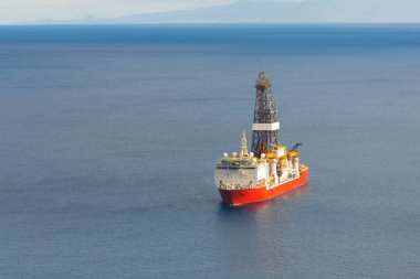 offshore oil and gas drillship, blue sea background, aerial view clipart