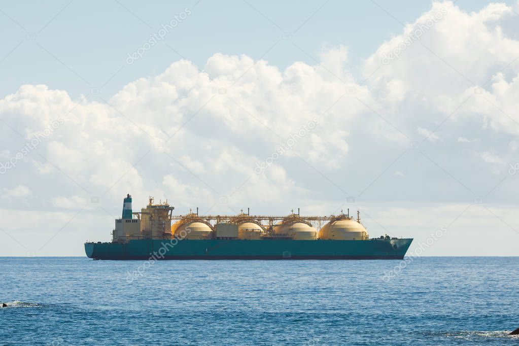 liquefied natural gas LNG transportation tanker ship, blue sea and sunny sky backgound