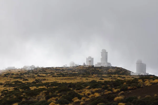 Teide Observatory astronomical telescopes in Tenerife, dense clouds background — Stock Photo, Image