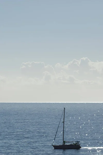 Wolken aan de hemel en blauwe zee met jacht silhouet — Stockfoto