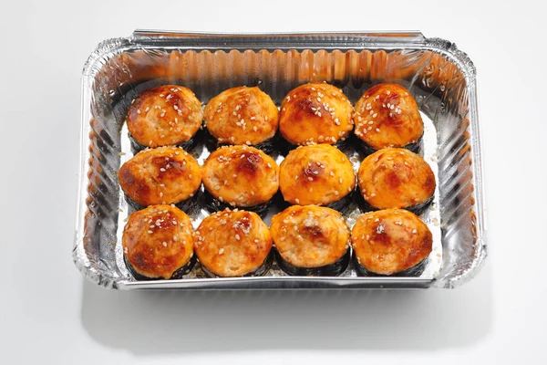 Baked sushi rolls in a foil box container — Stock Photo, Image