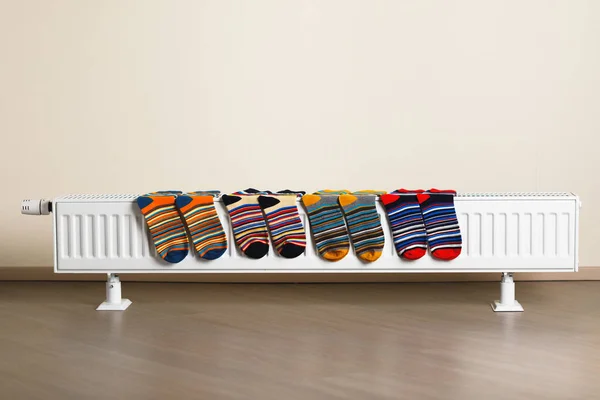 Colorful socks are being drying on the radiator — Stock Photo, Image