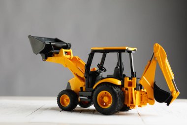 konut inşaat planı üzerinde traktör oyuncak, gri arka plan