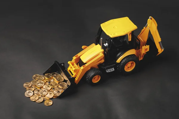 Tractor rake up money coins with a bucket — Stock Photo, Image