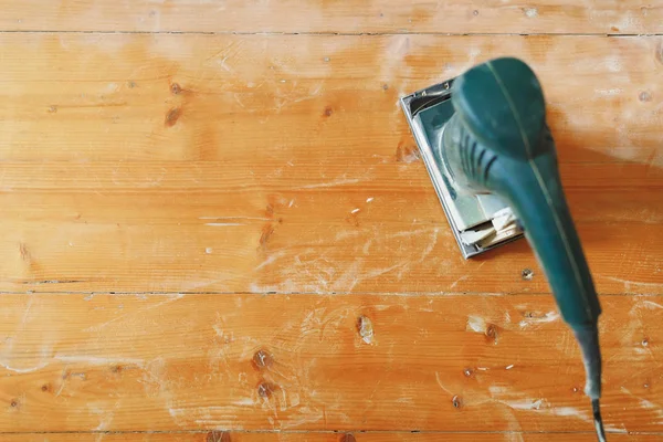 Wooden floor sanding with flat sander tool — Stock Photo, Image