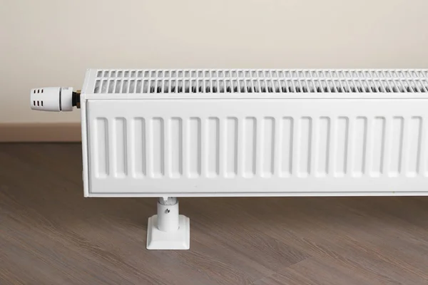Topné těleso s termostatickým knoflíkem v obývacím pokoji — Stock fotografie