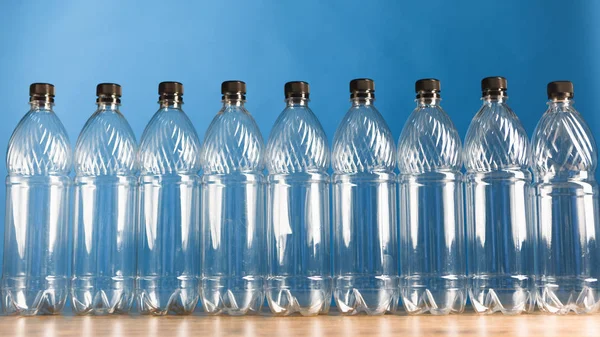 Empty plastic bottles on blue background — Stock Photo, Image