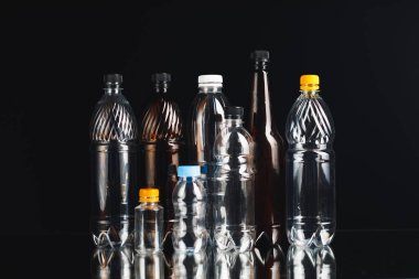 variety of plastic bottles on black background clipart